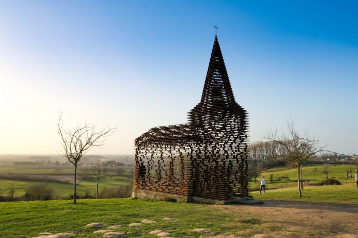 这是2月24日在比利时小镇博尔赫隆附近拍摄的"透明教堂"与落日景观.